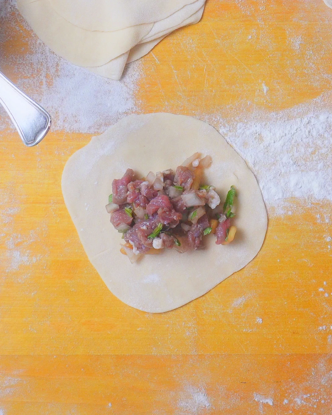 Lamb and pumpkin filling on a round dough wrapper